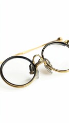 Gold-rimmed spectacles, round lenses, ornate details.