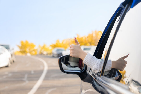 Positive Vibes on the Road: A Female Driver's Thumbs Up for Joyful Driving Experiences