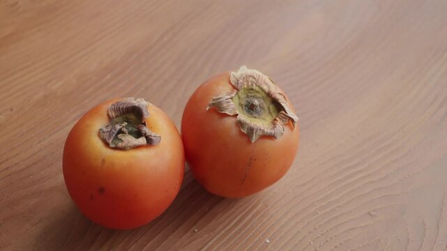  persimmon on wooden table