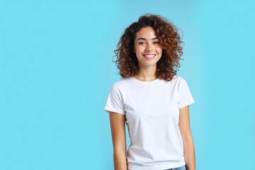 young woman standing against light blue background white t shirt