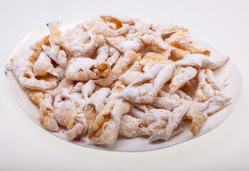 Angel wings (Faworki), cakes. Sweet pastry deep fried and sprinkled with powdered sugar