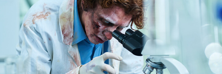 Undead Scientist Using Microscope In Lab Header