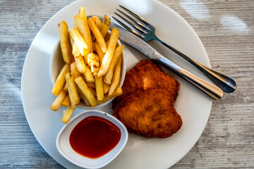 Breaded cutlet with french fries. Vienna steak, breaded and deep fried cutlet with french fries