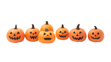 A group of eight lit spooky halloween pumpkins, Jack O Lantern with evil face and eyes isolated against a white background