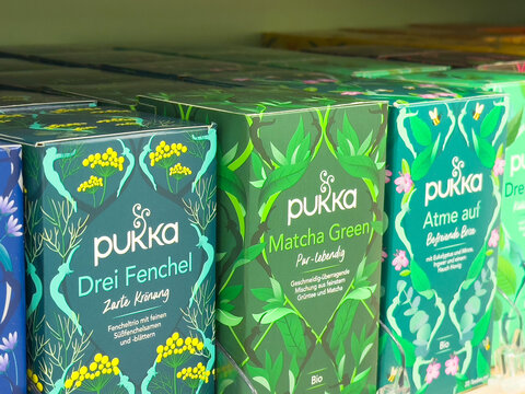 Variety of pukka herbal tea boxes with bright packaging on display shelf