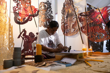 Craftsmen create traditional Thai Khon puppets.