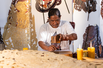 Craftsmen create traditional Thai Khon puppets.