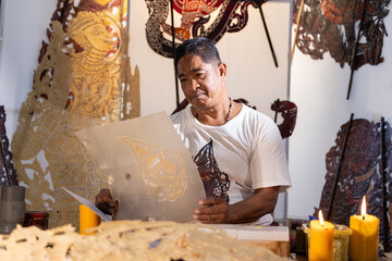 Craftsmen create traditional Thai Khon puppets.