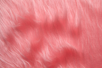 Luxurious pink faux fur background with a soft, fluffy texture and natural wavy patterns. Ideal for...