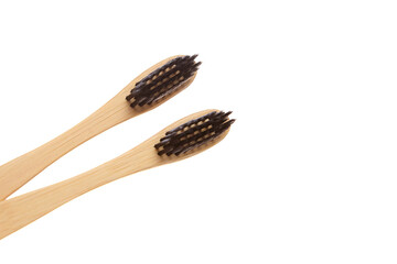 Close-up view of two eco-friendly bamboo toothbrushes with black bristles. A sustainable and biodegradable alternative for natural oral care and zero-waste living