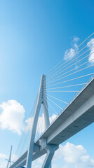 Obraz premium modern cable stayed bridge against clear blue sky with clouds