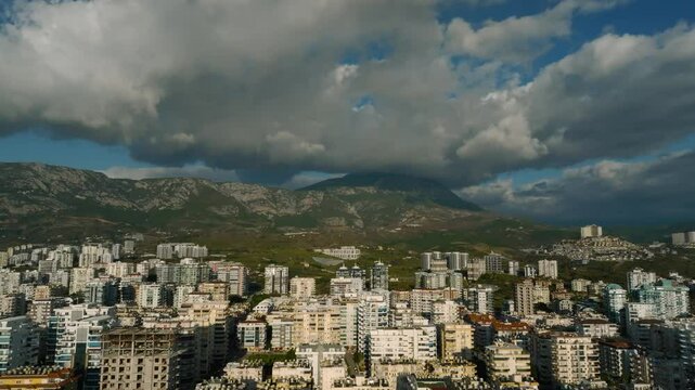 Aerial View of the Densely Built Coastline of Mahmutlar with Epic Mountain Clouds in Alanya Turkey