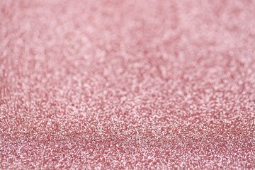 Beautiful pink glitter sparks texture as background with shallow depth of field