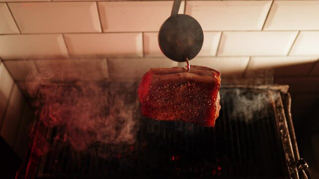 Cooking spiced lard over an open flame enhancing flavor and aroma in a kitchen setting