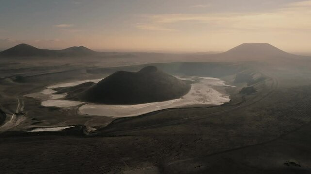 Aerial view from a drone of the black cone of Meke Lake crater with a black earth landscape in Turkey