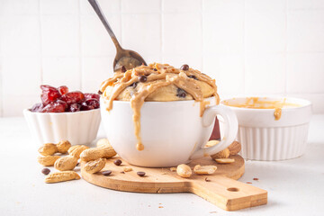 Healthy vegan Peanut Butter banana bread Mugcake, Rich and delicious peanut buttery microwave made mug cake with dates, chocolate drops, with Peanut Butter topping, nuts and chocolate