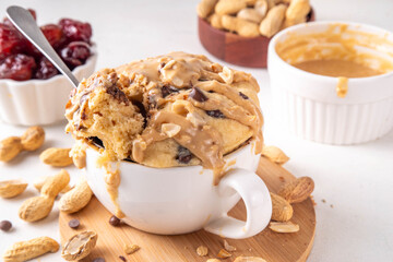 Healthy vegan Peanut Butter banana bread Mugcake, Rich and delicious peanut buttery microwave made mug cake with dates, chocolate drops, with Peanut Butter topping, nuts and chocolate