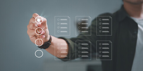 assessment survey online. Businessman with evaluating questionnaire on online laptop computer. choose correct answer in test, questions test, online exam, quiz knowledge, filling out an survey form.