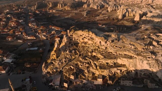 Drone view of the &Ccedil;avuşin Kalesi castle caves in the sunset rays in Cappadocia
