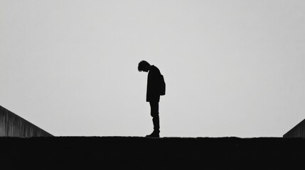 Silhouetted person, despair, urban backdrop, contemplation, mental health
