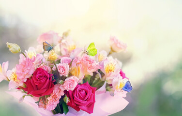 Beautiful composition with butterflies on flowers bouquet close up, abstract nature background. gentle lovely floral image. Greeting card design. symbol of love, romance.