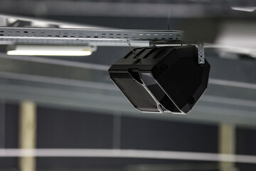 Ice hockey arena rink speaker hanging near ceiling.