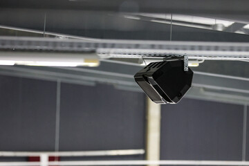 Ice hockey arena rink speaker hanging near ceiling.