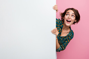 Portrait of overjoyed woman with bob hair wear print blouse hold white wall look at offer empty...
