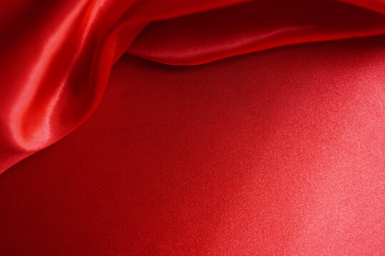 abstract background red silk or satin velvet. Luxurious, elegant. Curtains, curtains, flowing waves background work or backdrop work