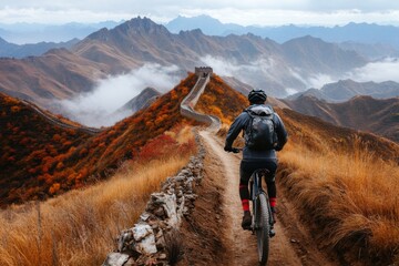 A cyclist riding along a rugged section of the Great Wall, combining adventure with breathtaking views