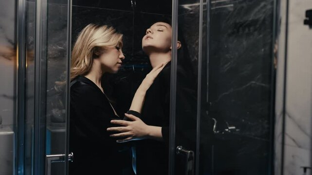 Two women sharing a close moment together in a modern interior.
