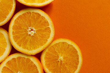 round slice of fresh orange fruit on orange background
