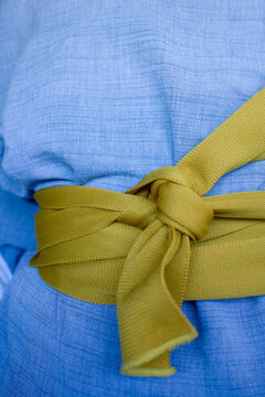 Close-up of a blue kimono with a yellow bow tied around the waist, traditional Japanese fashion culture, Tokyo, Japan