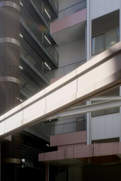 Modern building facade with a skybridge connecting two high-rise structures. Tokyo, Japan