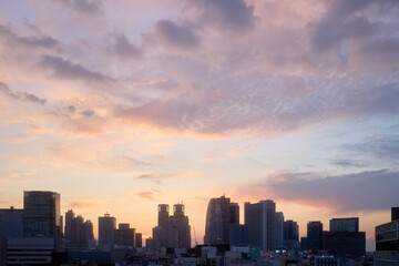 City skyline at sunset with colorful clouds and silhouetted buildings. Tokyo, Japan