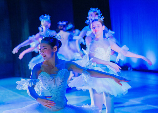 Ballet dancers perform gracefully on stage in elegant white costumes and sparkling tiaras, The Nutcracker, Bainbridge Island, USA