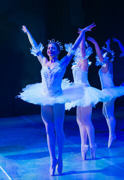 Three ballerinas in elegant white tutus performing a graceful ballet dance on stage. The Nutcracker, Bainbridge Island, USA