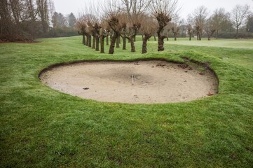 Tranquil golf course bunker on cloudy day