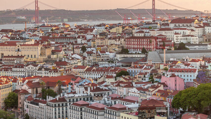 Tagus River and Bridge April 25 or Ponte 25 de Abril aerial timelapse above Orange Roofs of houses in Lisbon, Portugal.