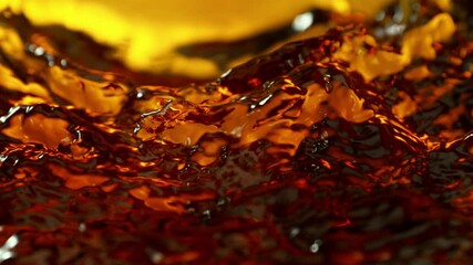 Super Slow Motion Detail Shot of Waving Golden Liquid at 1000fps.