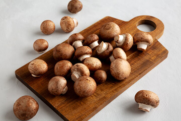 Raw Royal Brown Champignon on a wooden board, side view.