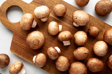 Raw Royal Brown Champignon on a wooden board, top view.
