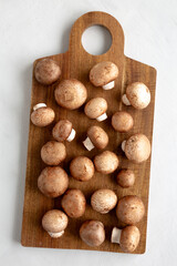 Raw Royal Brown Champignon on a wooden board, top view.