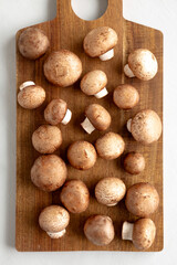 Raw Royal Brown Champignon on a wooden board, top view.