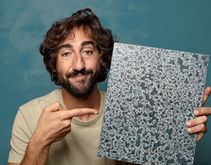 young adult bearded man with a textured canvas