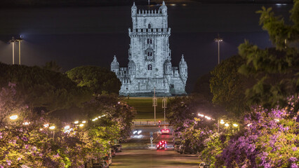 View of Avenida Torre de Belem night timelapse, with cars and the Belem Tower in the background....