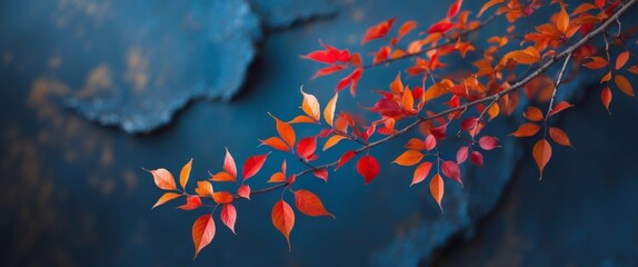 Autumnal Branch with Red and Orange Leaves on Dark Blue Textured Background