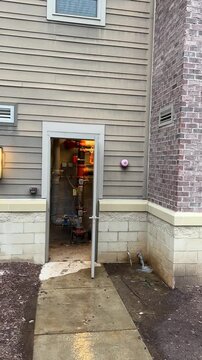 Fire sprinkler riser room with water rushing out of a pipe