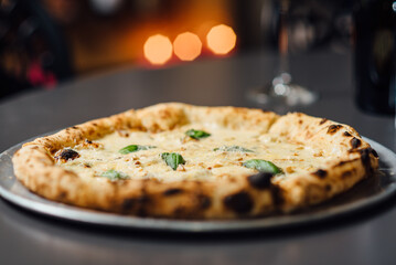 Gourmet Four Cheese Pizza with a creamy signature sauce, featuring mozzarella, gorgonzola,...