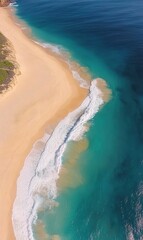 Aerial view of turquoise ocean waves crashing on golden sandy beach, perfect for travel ads